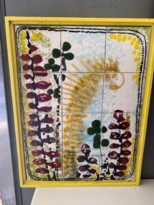 RT sent me a midcentury painted mosaic tile plaque, a curious image of a yellow fern with green and red foliage signed EC or CC Bealle.