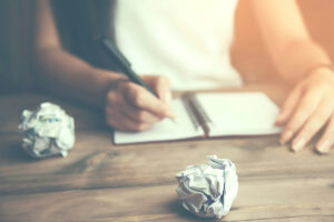 female hand take notes with a pen in a notebook.